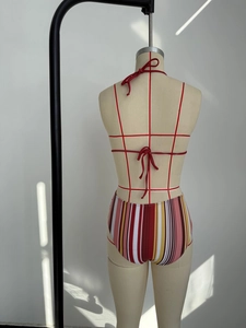 Detail of multi-color striped bikini set showing halter neck tie and back bow closure