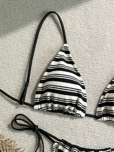 Chic black and white striped bikini set with textured fabric for women's beach vacation