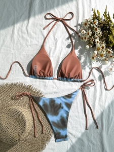 Zweiteiliges Bikini-Set mit ziegelrotem Neckholder-Top und blau bedruckter Hose im Batik-Stil