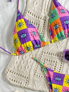 Detail of bohemian bikini set with colorful checkerboard and evil eye pattern print