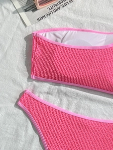 Detail view of hot pink bikini with waffle texture fabric and strapless bandeau top