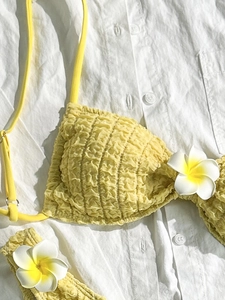 Sexy bright yellow smocked bikini top with white plumeria flower detail for vacation