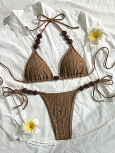 Brown knit triangle bikini set with halter neck and wooden bead accents on white background