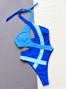 Flat lay of a cutout halter one-piece swimsuit in blue color-block design