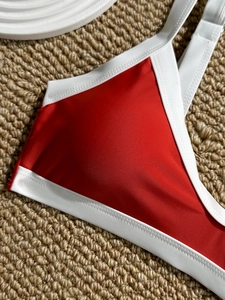 Two-piece color block bikini with red shiny fabric and white contrast piping detail