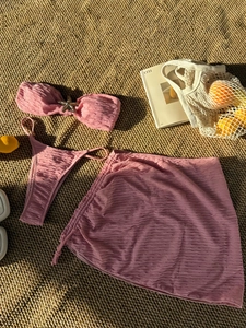 Pink three-piece bikini set with starfish ornament and pleated fabric texture detail