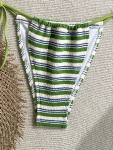 Detail of striped seersucker bikini bottoms with adjustable green side-tie strings