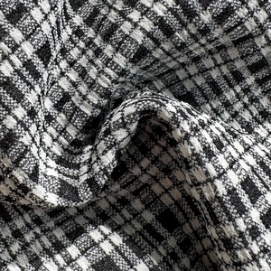 Macro view of black and white tweed fabric texture for high-end bikini beachwear detail