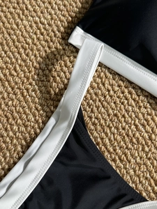 Detail of black and white color block bikini with durable double-stitched wide shoulder straps