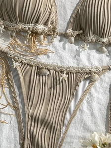 Detail of ribbed bikini set with shell and starfish charms on crochet lace trim