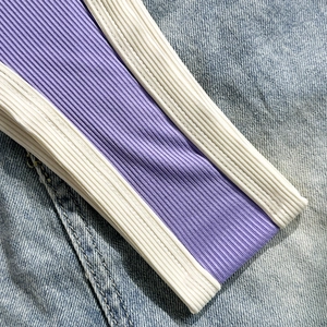 Detail der farblich abgesetzten Rippstrickkante und des hellblauen Denim-Stoffs