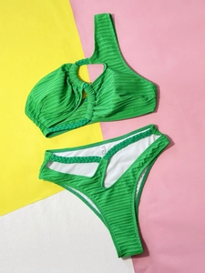 Flat lay of green ribbed bikini showing one-shoulder cut and woven ring details