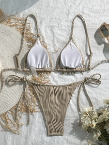 Detail of beach-colored ribbed bikini set featuring shell trim and halter tie closures