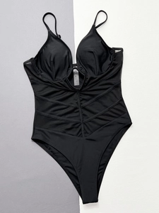 Detailed view of black one-piece swimsuit with mesh panels and 95% cotton material