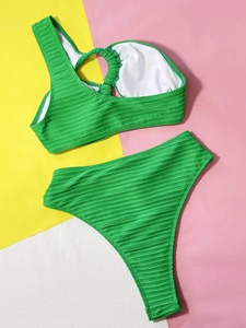 Detail of emerald green ribbed bikini featuring a one-shoulder top and high-waisted bottom