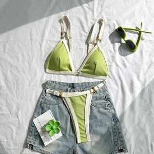 Detail eines lindgrünen Ripp-Bikinis mit Schildpatt-Ringen und weißem Saum-Akzent