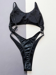 Two-piece black bikini with snake pattern texture and high-cut bottoms in flat lay view