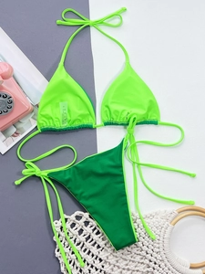 Detailed view of neon green and forest green bikini set with size S wash label and fabric info