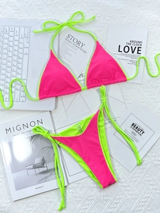 Flat lay of neon pink and green triangle bikini set with side tie high cut bottoms