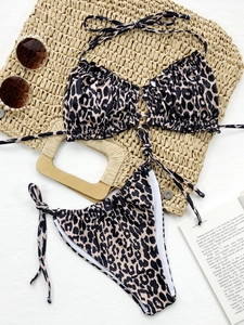 Detailed flat lay of leopard print bikini with halter pleats and side-tie bottoms