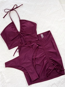 Deep burgundy 3-piece swimwear set with halter top and drawstring skirt flat lay view