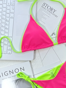 Flat lay of pink and neon green bikini set made of 80% nylon and 20% spandex