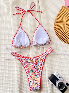 White floral bikini set with red scallop trim and high cut bottom on waffle fabric