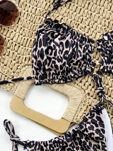 Detailed flat lay of a leopard print bikini with ruffled edges and adjustable tie straps
