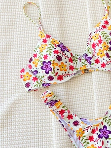 Vibrant floral print bikini set with underwire top and ruched bottoms on waffle fabric