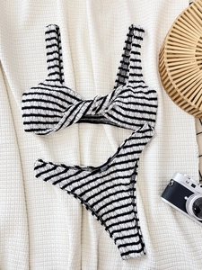 Two-piece black and white striped bikini with seersucker texture and knotted front design