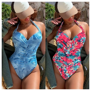 Detail of ruched one-piece swimwear featuring halter V-neck and tropical floral prints