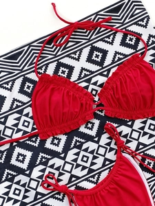 Close-up of red ruffled bikini with adjustable ties and premium elastic fabric texture