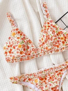Women's floral print two-piece bikini with ruffled edges and off-white floral pattern