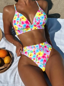 Vibrant floral print two-piece high waisted bikini set for women on beach sand