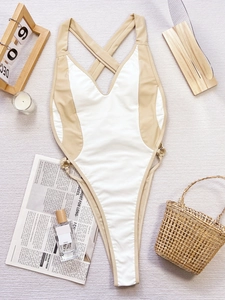 Flat lay of a cutout monokini with contrasting color block design and lace-up details