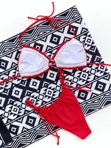 Close-up of red two-piece bikini set with tie-side bottoms and 80% nylon fabric detail