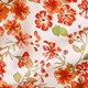 Close-up of vibrant orange and red floral patterns on soft bikini fabric texture