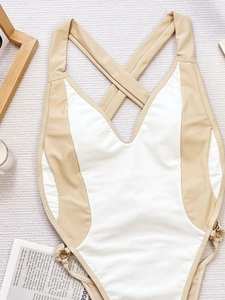 Close-up of contrast color bikini with criss-cross back straps and side drawstring details
