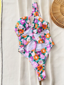 One-shoulder cutout swimsuit featuring vibrant floral print and side drawstring details