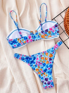 Blue floral two-piece bikini set with adjustable straps and white lace trim detail