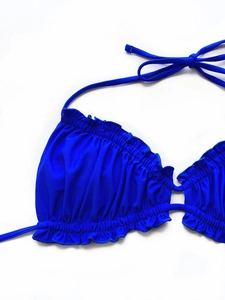 Detail of royal blue bikini top with elegant ruffle trim and double strap halter design