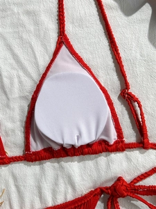 Detail of red bikini top featuring white inner lining and removable round breast pads