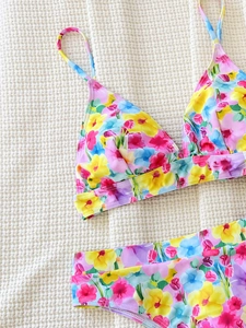Two-piece bikini set with vibrant yellow, pink and purple floral tulip pattern design