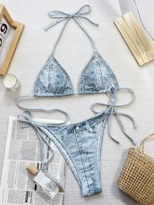 Two-piece bikini set with denim print texture and halter neck triangle top on flat lay