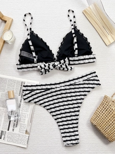 Women's black and white striped bikini set with high-waisted bottoms on white background