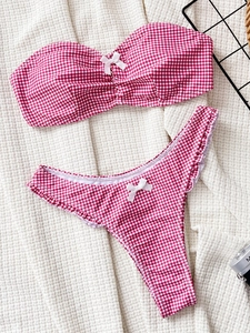 Women's red and white gingham bikini set with bandeau top and ruffled thong bottom