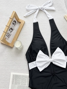 Retro halter one-piece swimsuit with chic black and white bow tie contrast detailing