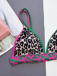 Detail of leopard print bikini top with neon piping and handcrafted braided band