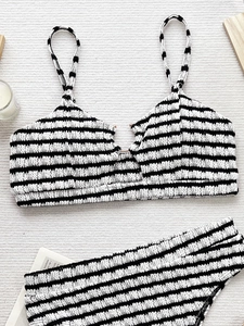 Women's two-piece bikini set with black and white seersucker stripes on a clean background