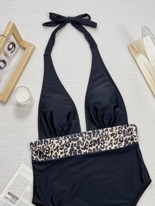 One-piece halter swimsuit in black with leopard print waist detail on neutral background